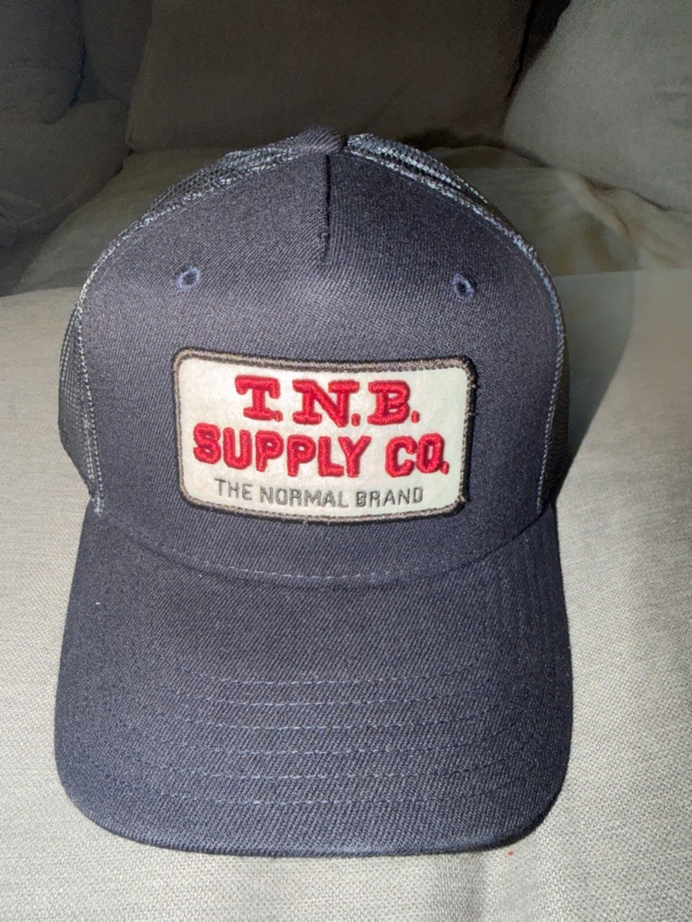 The Normal Brand Navy Trucker Hat with Red Patch